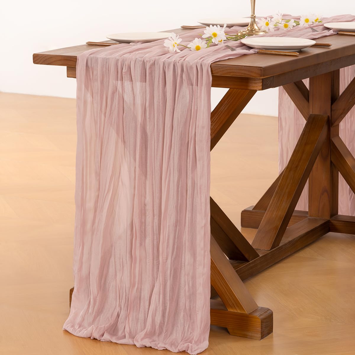 Socomi baby shower setup featuring pink cheesecloth runner for soft décor.