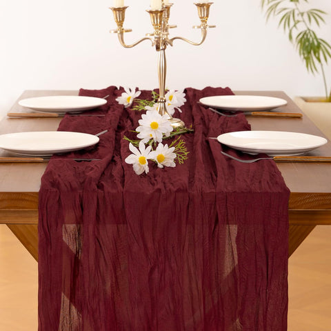 Socomi burgundy red cheesecloth runner on a dining setup for intimate event