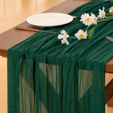 Socomi emerald-green cheesecloth table runner enhances a romantic wedding tablescape