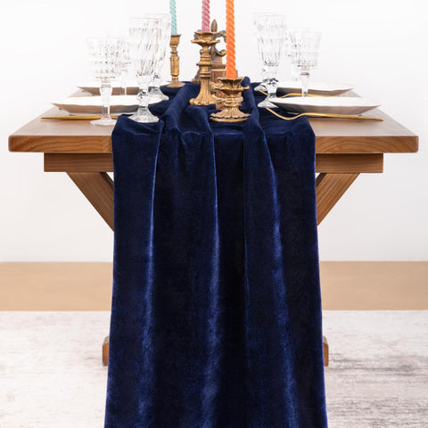 Socomi navy blue velvet table runner draped on table for festive gatherings.