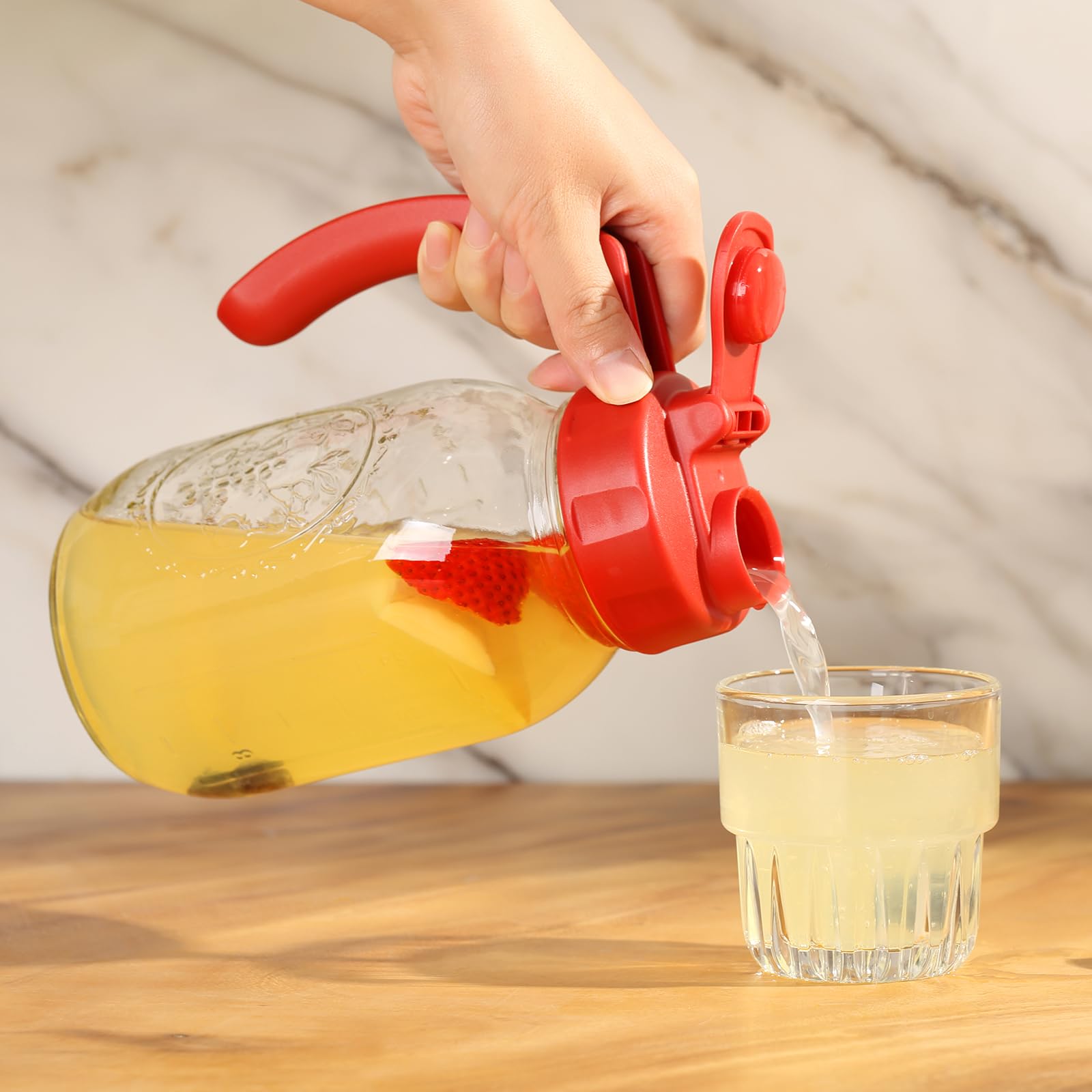 SOLIGT lid in use pouring cold brew from a regular-mouth jar.