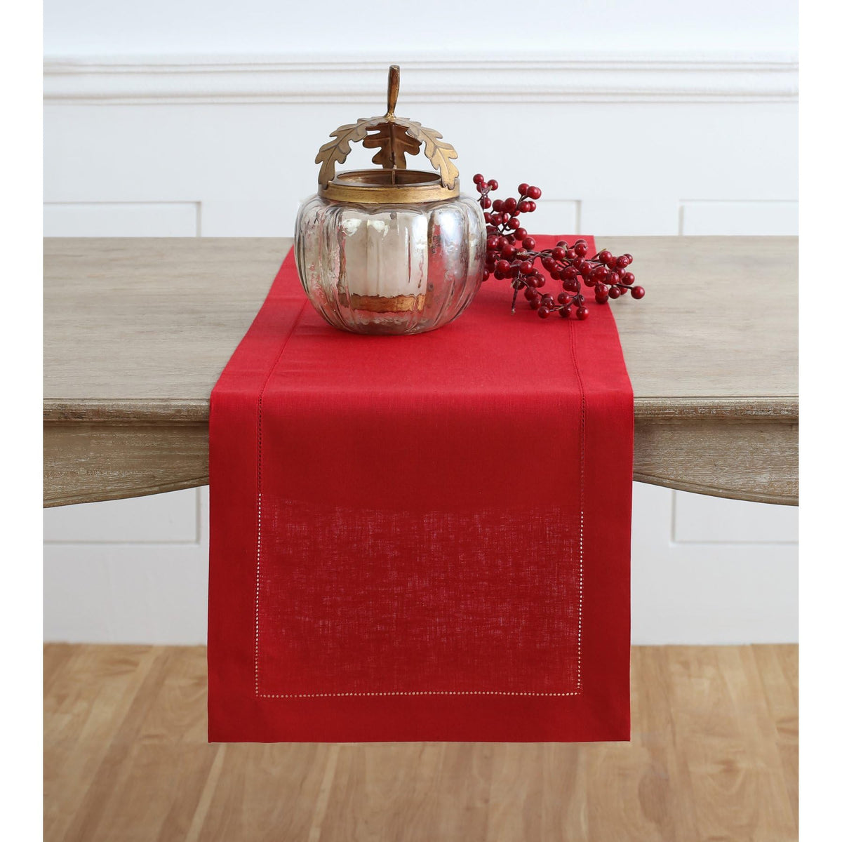 Solino Home red table runner on a long dining table for an elegant centerpiece