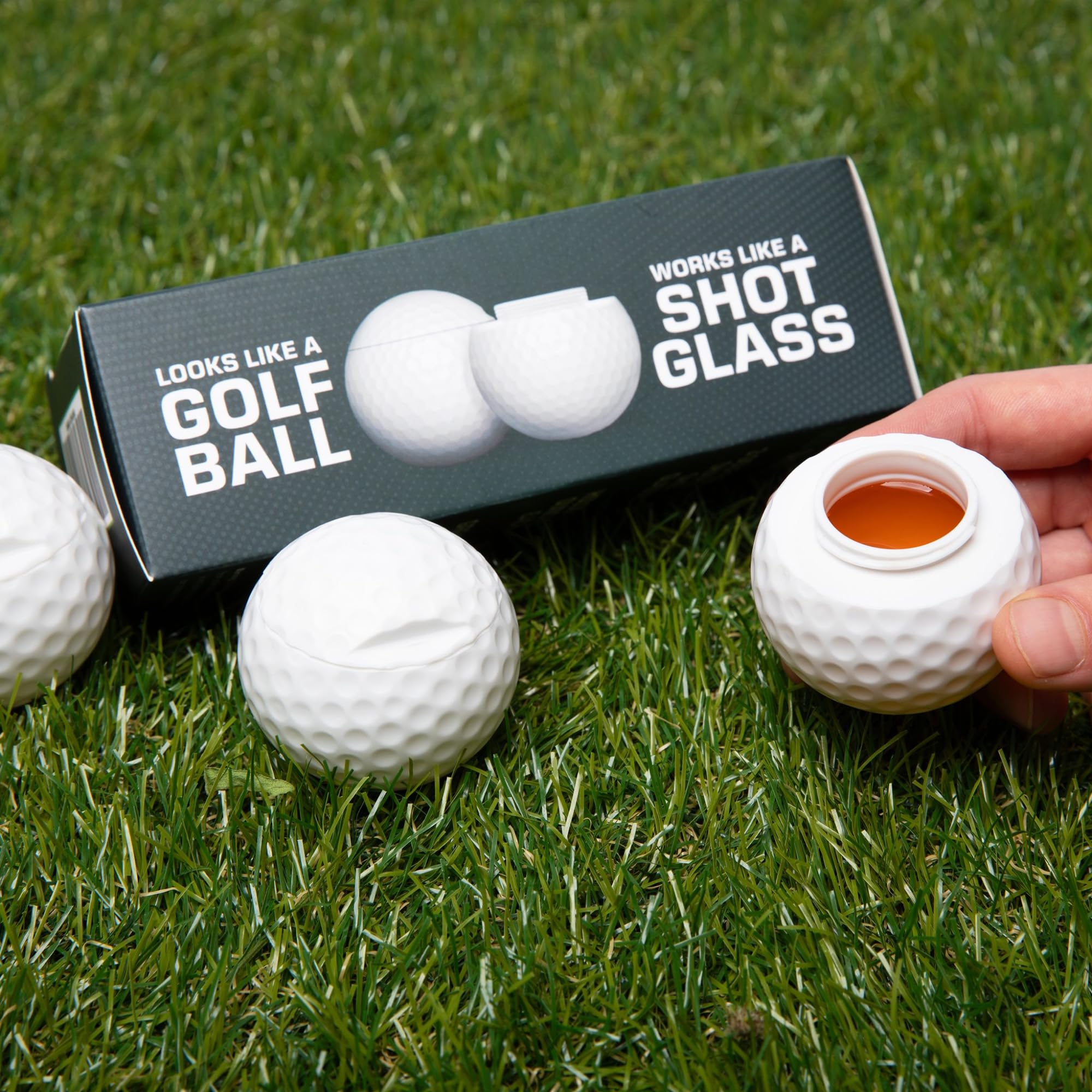 Sport Shots golf-ball design sits beside clubs and a tee.