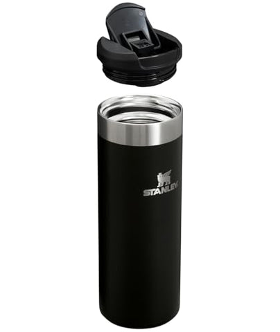Stanley AeroLight bottle resting in car cup holder, ultralight for daily travel.