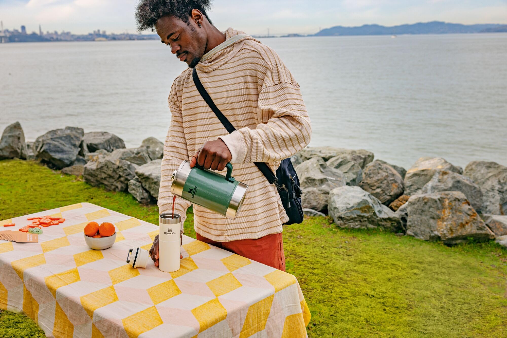 STANLEY Classic Stay-Hot French Press camping-ready setup on rugged outdoor table.