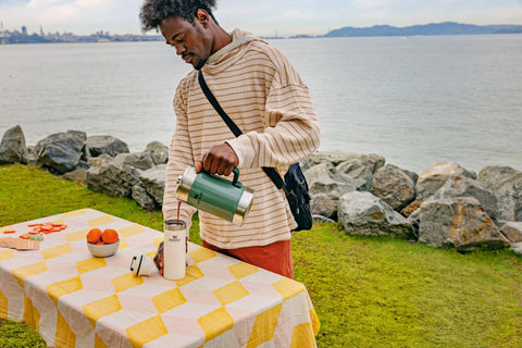 STANLEY Classic Stay-Hot French Press camping-ready setup on rugged outdoor table.
