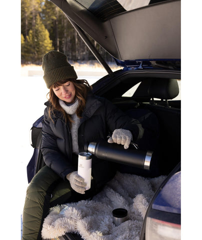 Stanley vacuum bottle in use keeps coffee hot on the road.