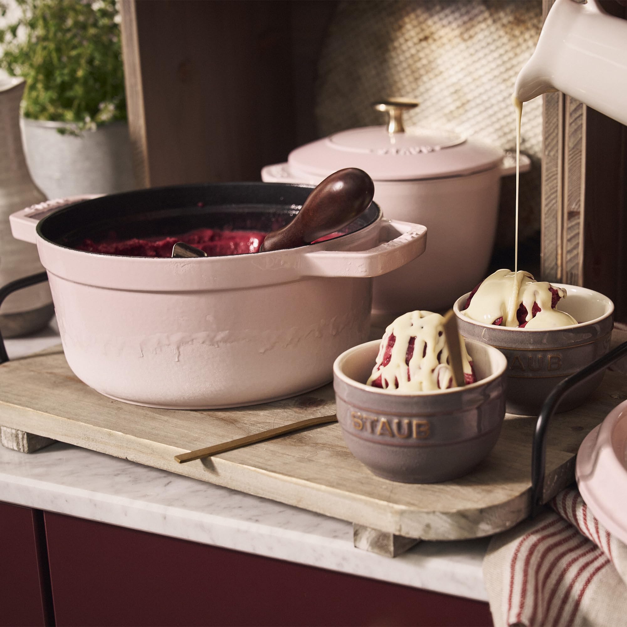Staub Peony Pink Dutch Oven handle side shows ergonomic design for comfortable lifting.