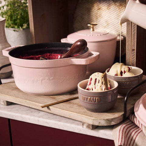 Staub Peony Pink Dutch Oven handle side shows ergonomic design for comfortable lifting.