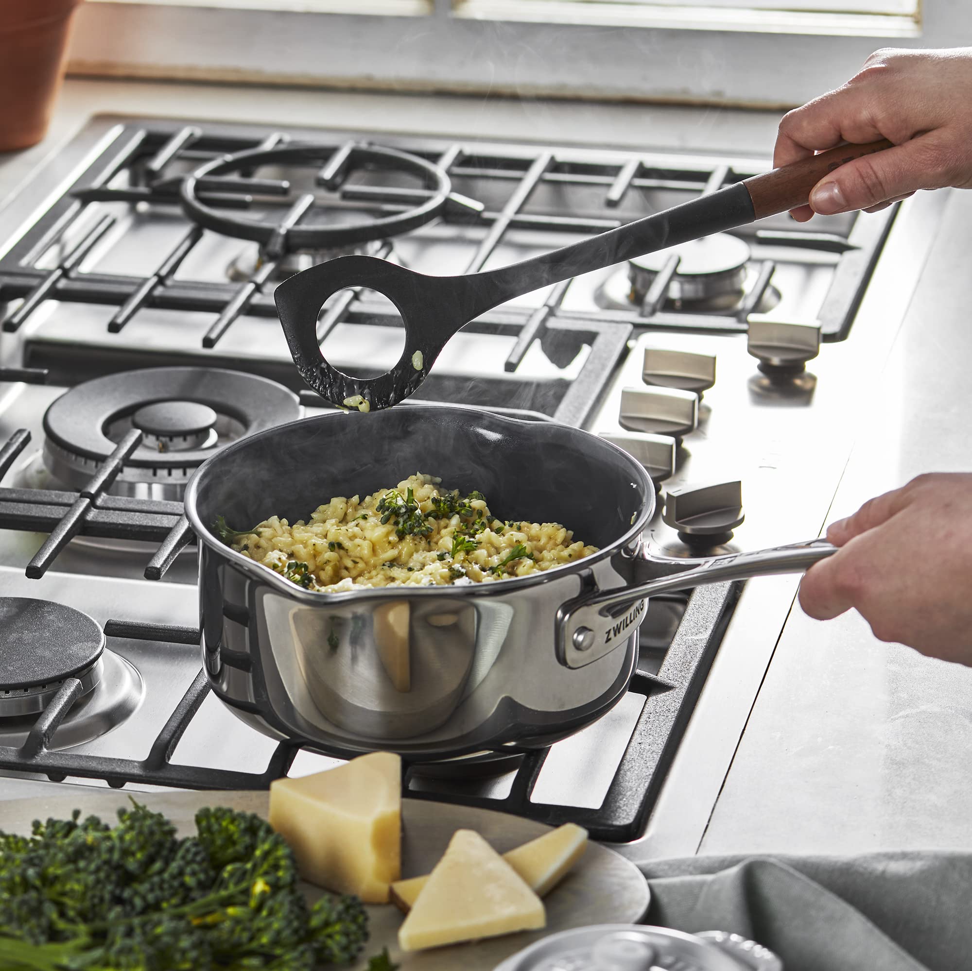 STAUB risotto spoon with acacia wood handle for comfortable grip.