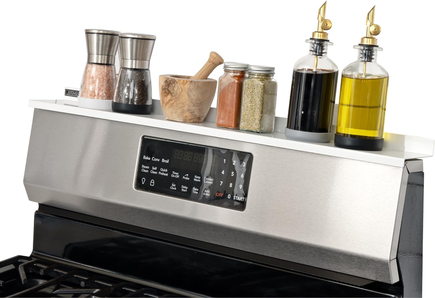 Stove Shelf magnetic shelf on stove top keeps spices within easy reach.