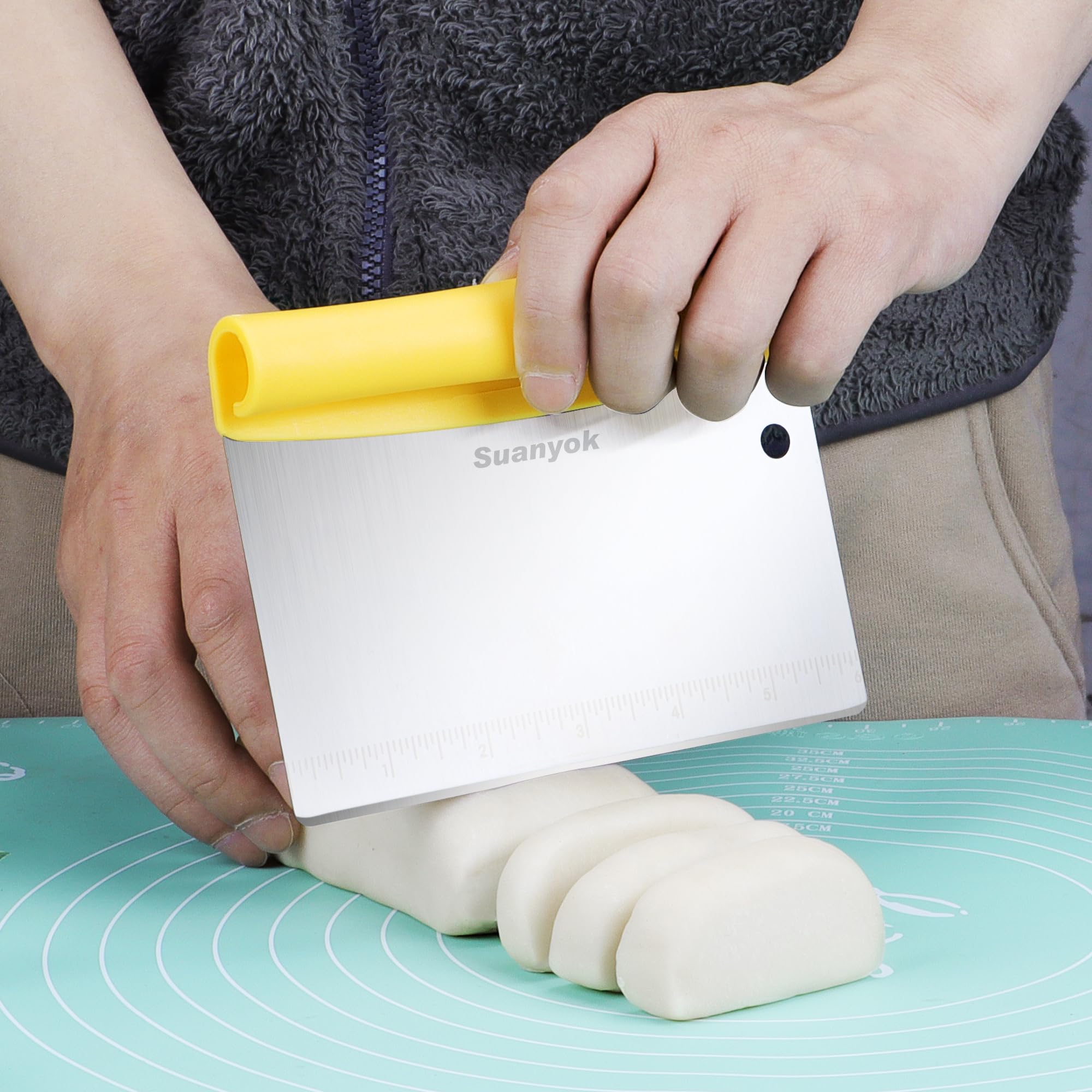 Suanyok flexible plastic dough scraper with handle for easy dough removal from bowls.