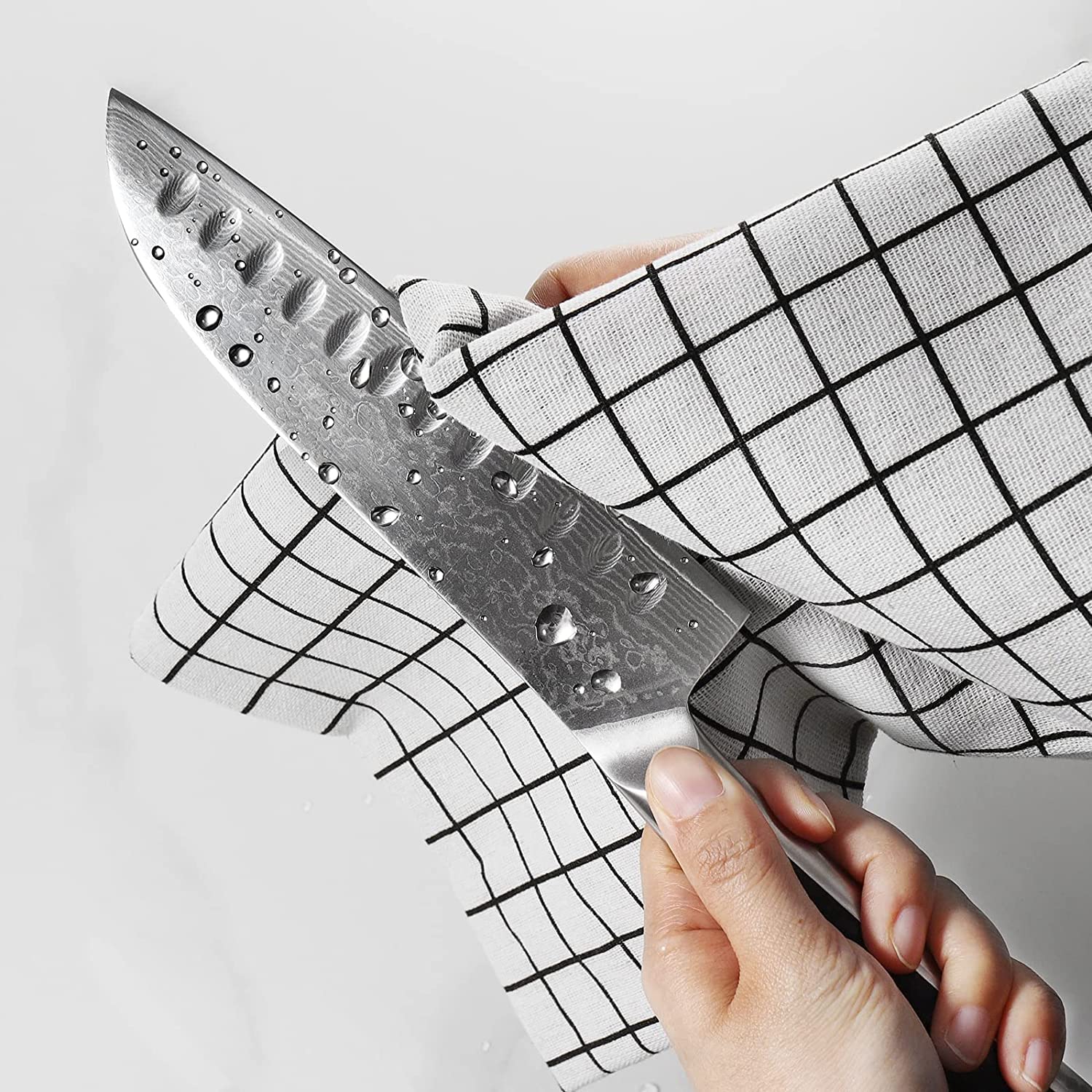 Sunnecko Santoku in action on a cutting board showing versatility.
