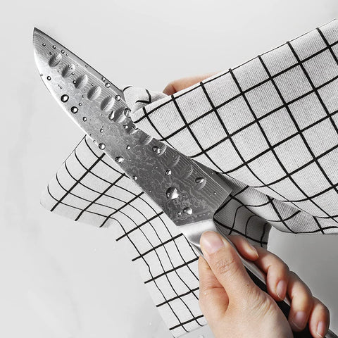 Sunnecko Santoku in action on a cutting board showing versatility.