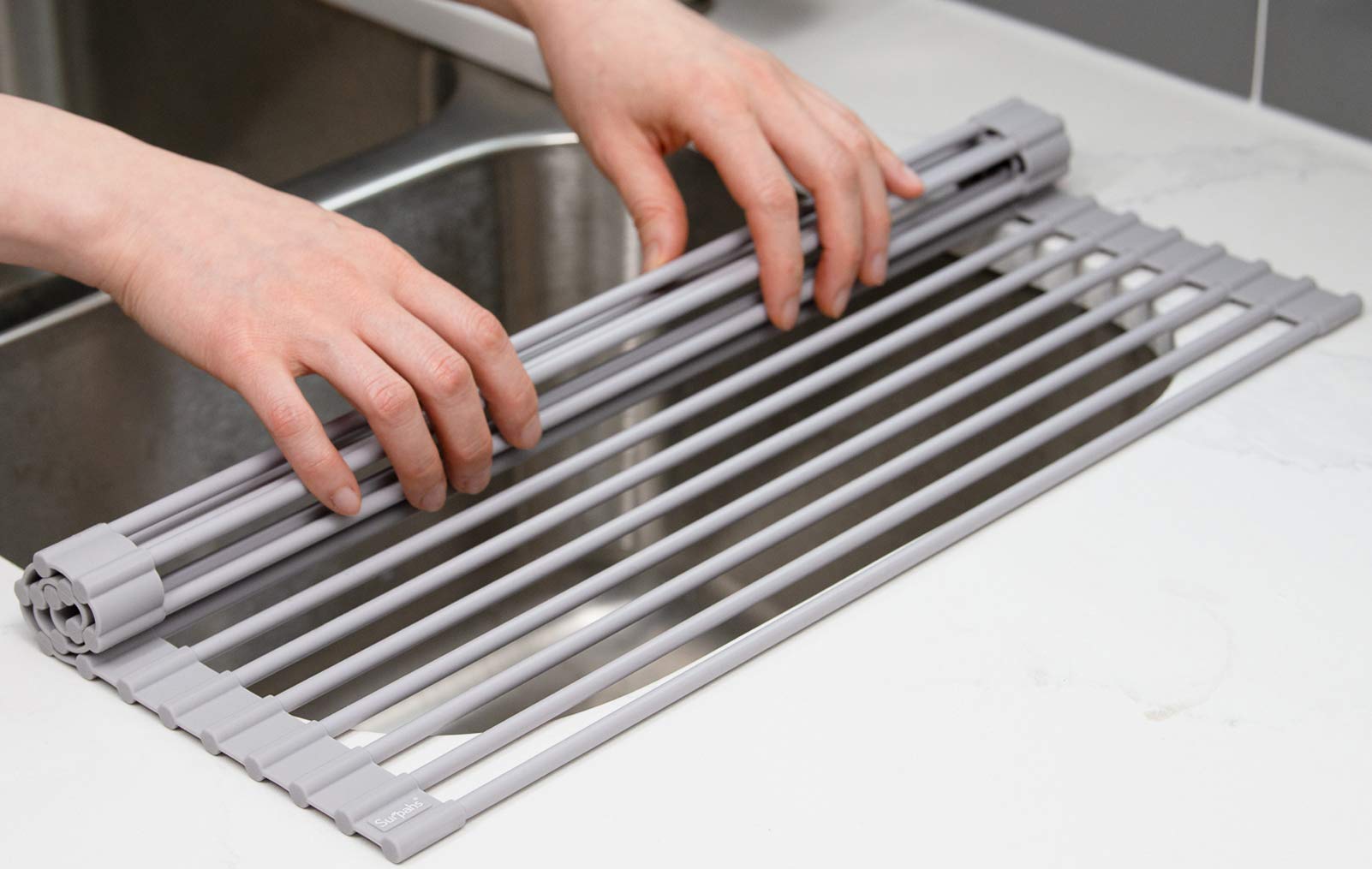 Surpahs roll-up rack in warm gray complements a modern kitchen setup.