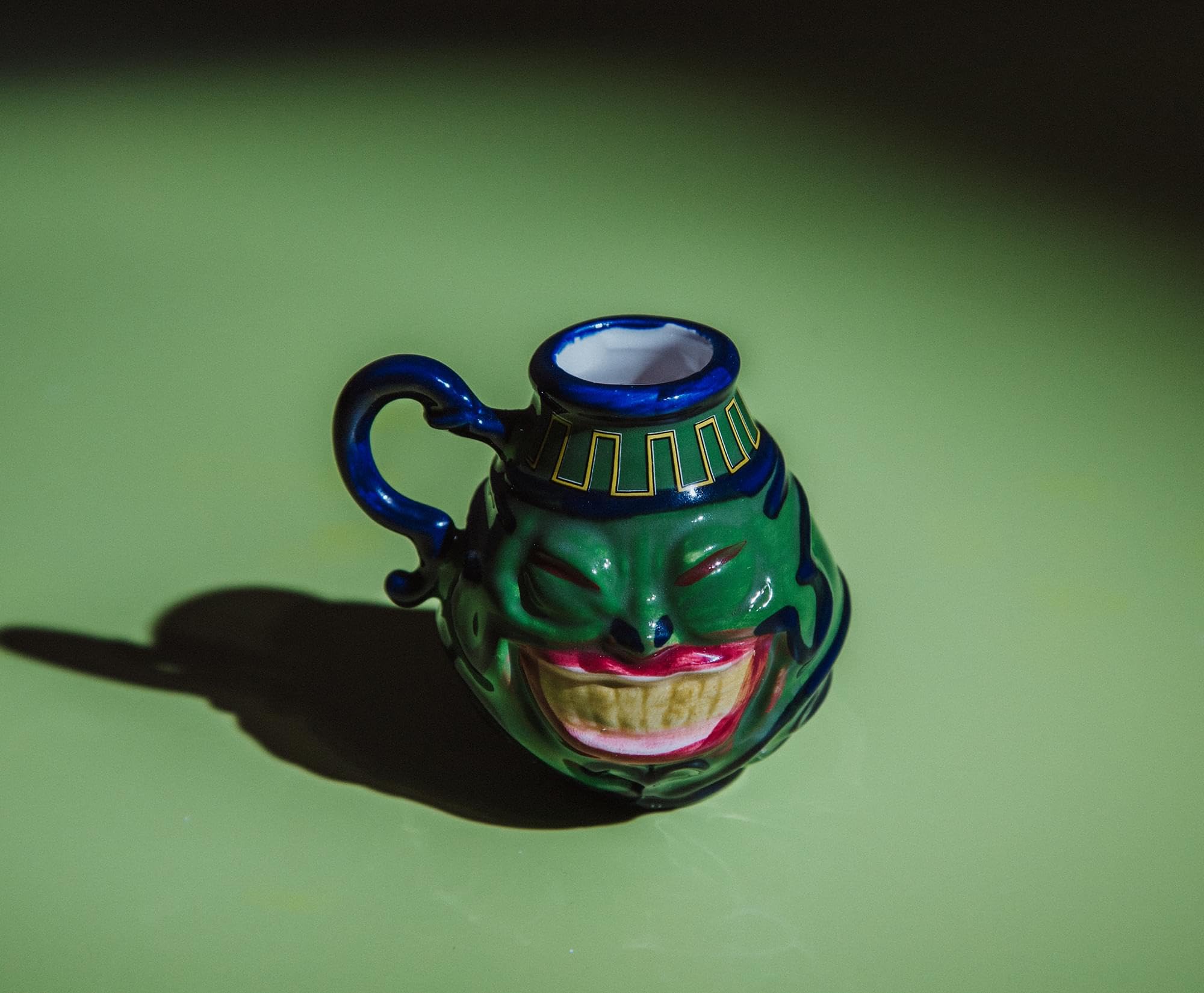 Surreal Entertainment Pot Of Greed mini mug blue flourishes provide vibrant accents.