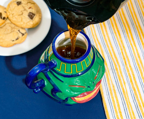 Surreal Entertainment Pot of Greed mug, in-use with coffee, showing versatility.