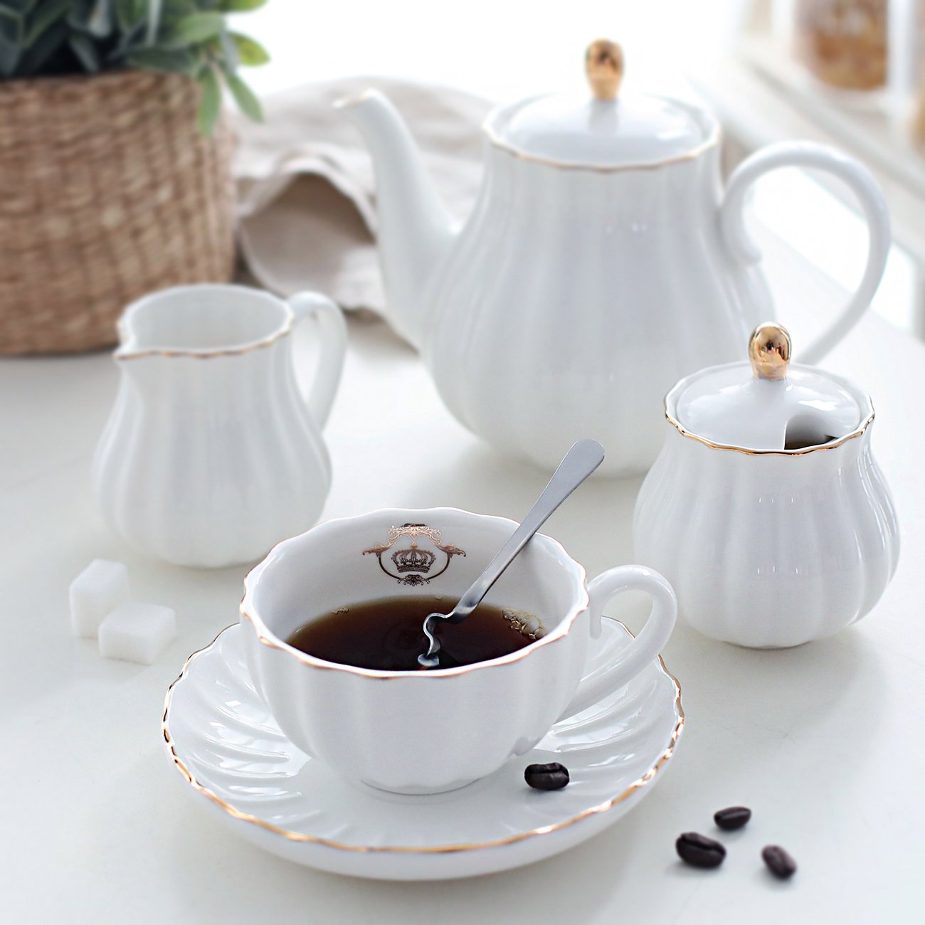 Sweejar teapot with glittering gold trim adds regal elegance to tea service.