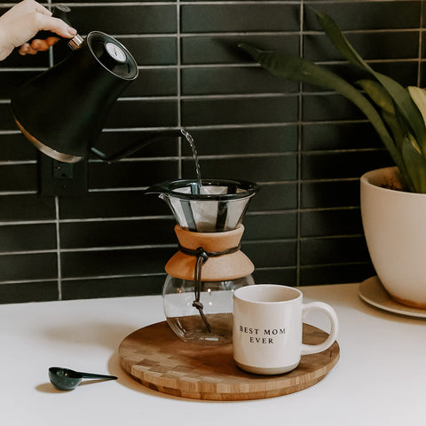 Sweet Water Decor Be Still and Know mug on office desk for warm beverages.