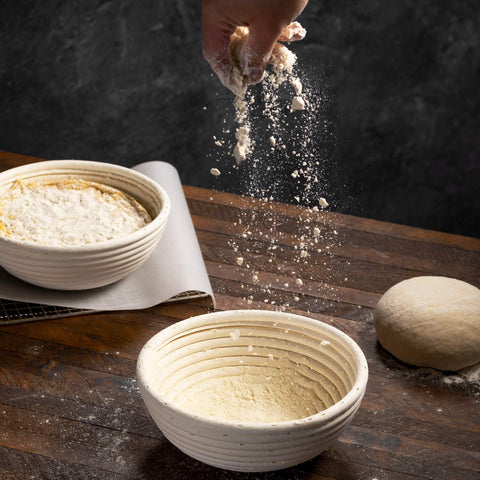 Swice Banneton round dough proofing in action on a floured surface.
