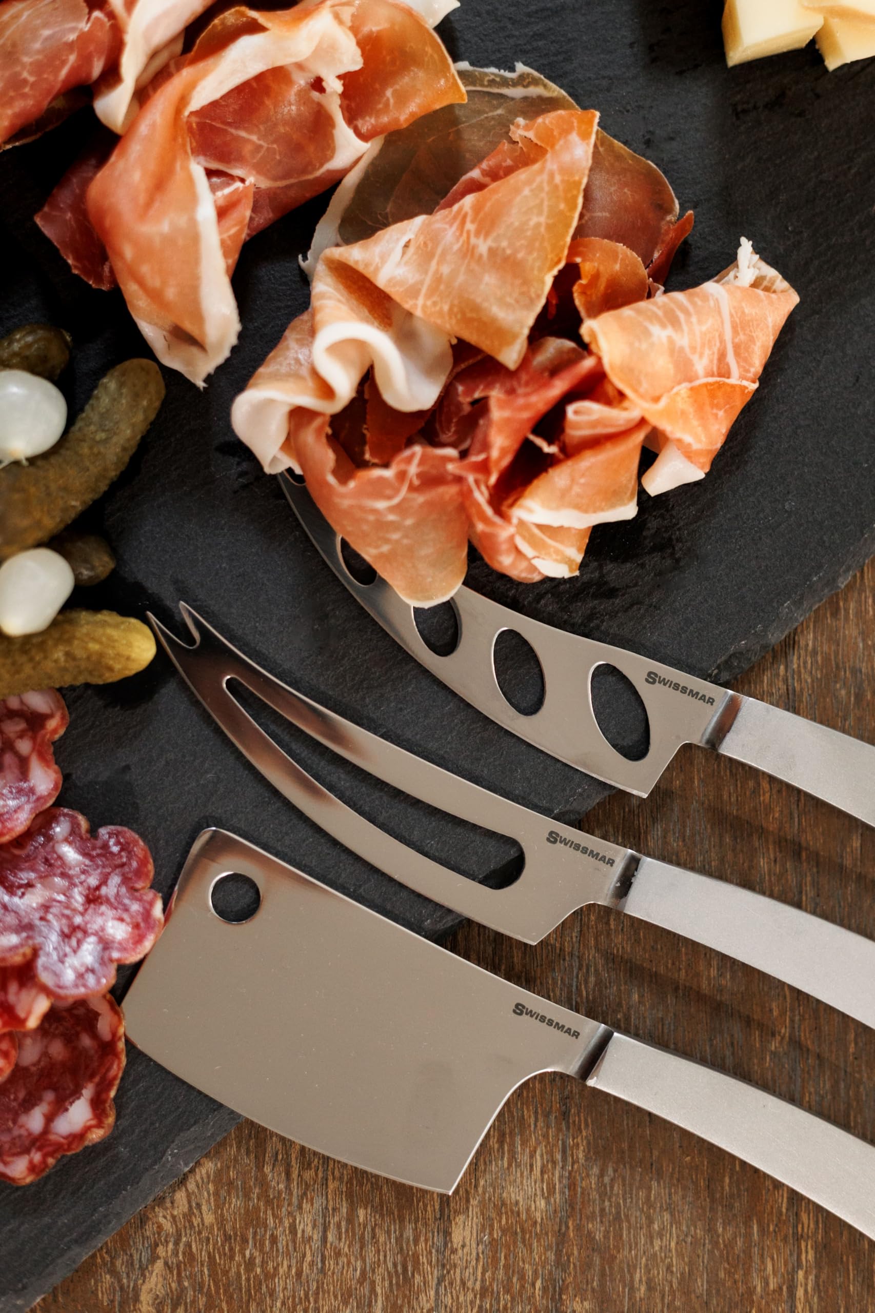 Swissmar Barcelona knife on a stylish cheese board elevates soft cheese tasting.
