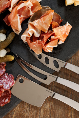 Swissmar Barcelona knife on a stylish cheese board elevates soft cheese tasting.