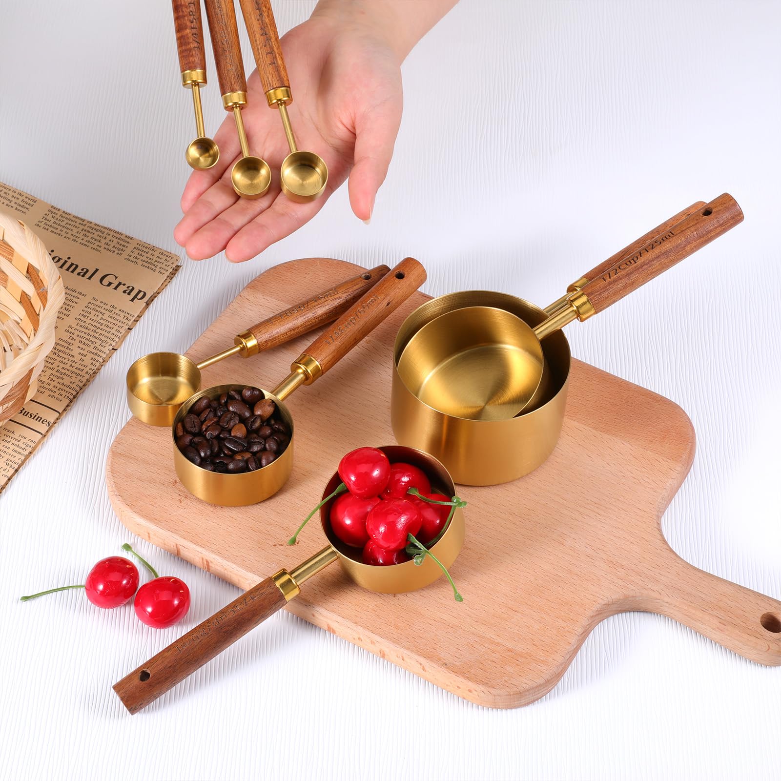 SynHHnergyx measuring spoons in gold finish with comfortable wooden handles.