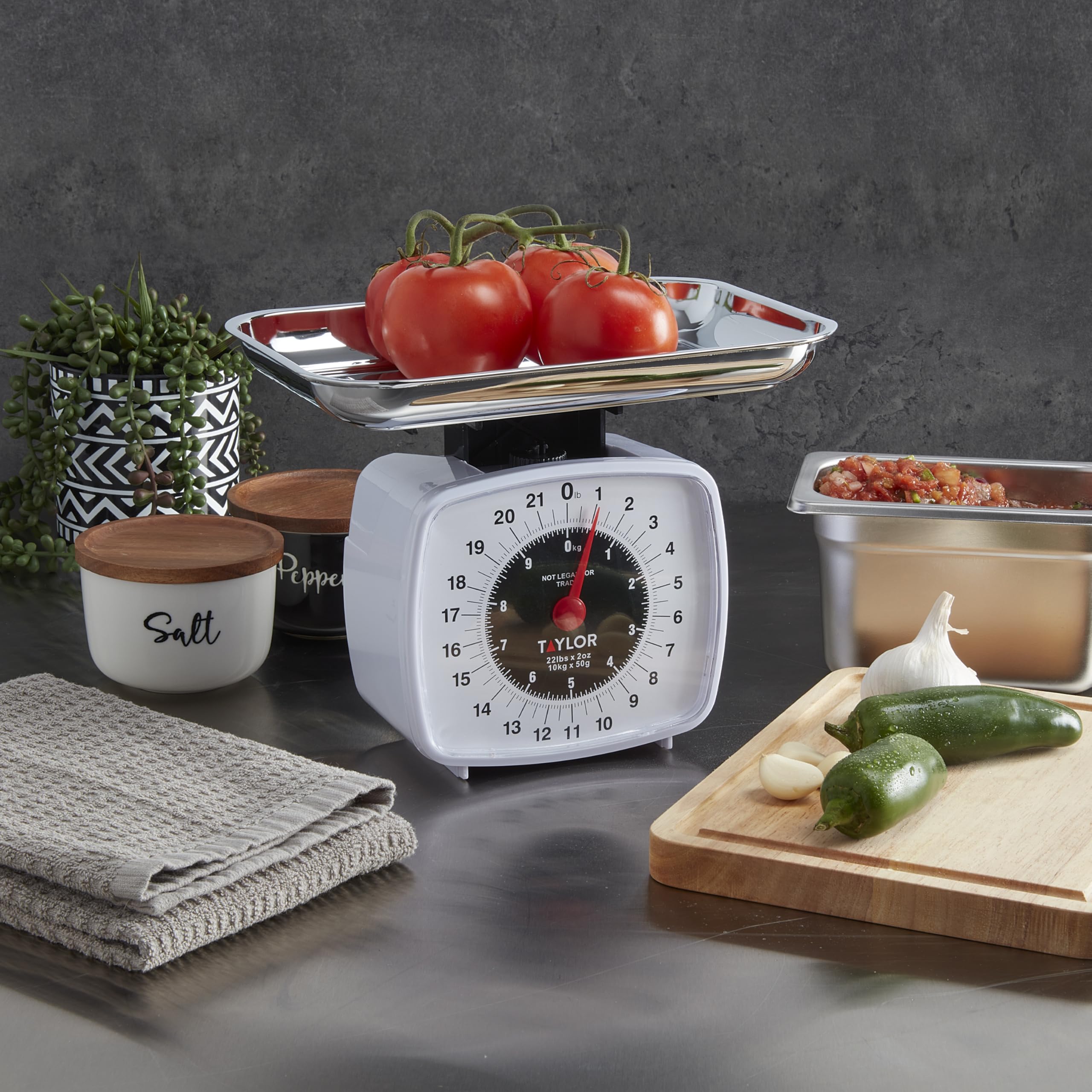 Taylor Analog Kitchen Scale includes a dishwasher-safe chrome tray.