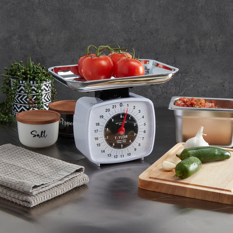 Taylor Analog Kitchen Scale includes a dishwasher-safe chrome tray.