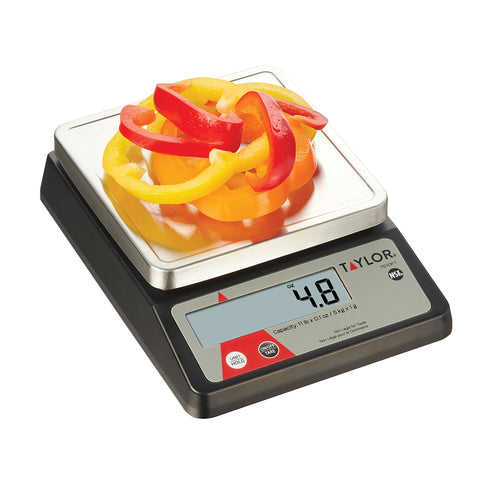 Taylor TE10FT compact kitchen scale on a busy prep counter.