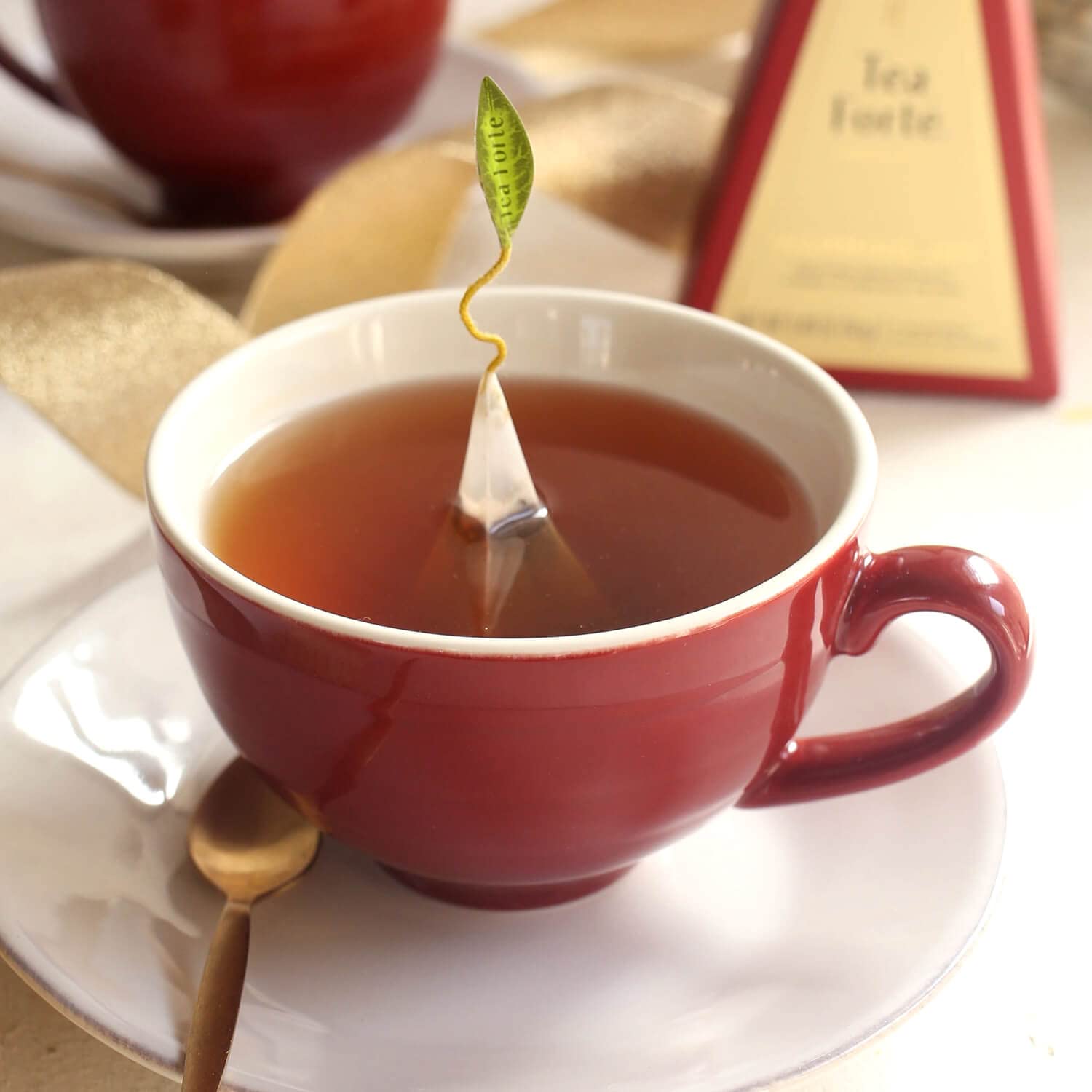 Tea Forte Cafe Cup Ruby Red with steeping hole lid for easy infuser access.