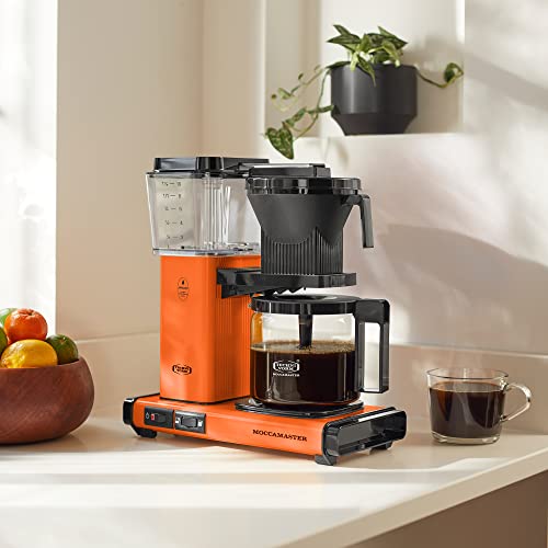 Technivorm Moccamaster orange model on a kitchen counter ready for daily use