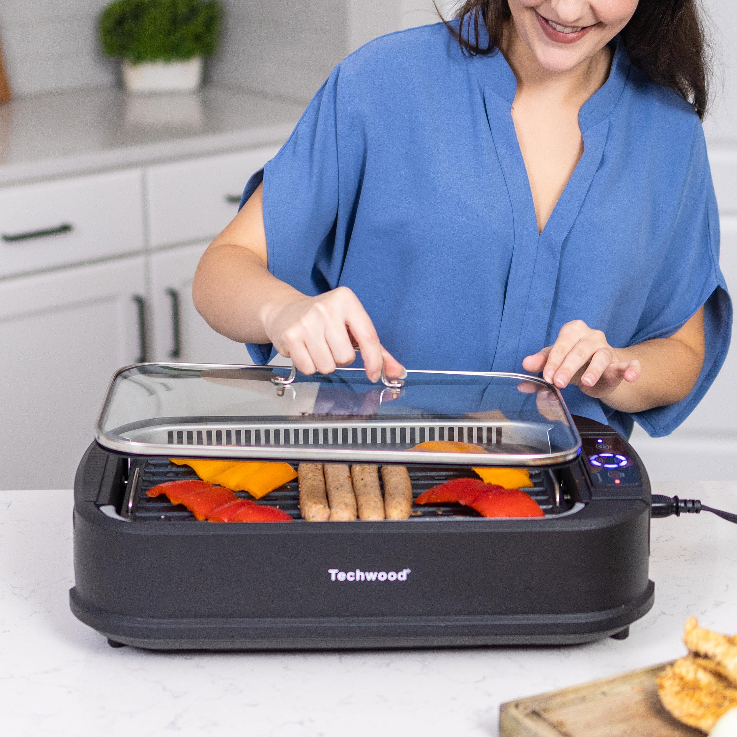 Techwood grill with tempered glass lid keeps heat visible and moisture locked.