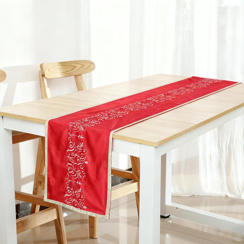 Tenceur table setting with candles and greenery on velvet runner.
