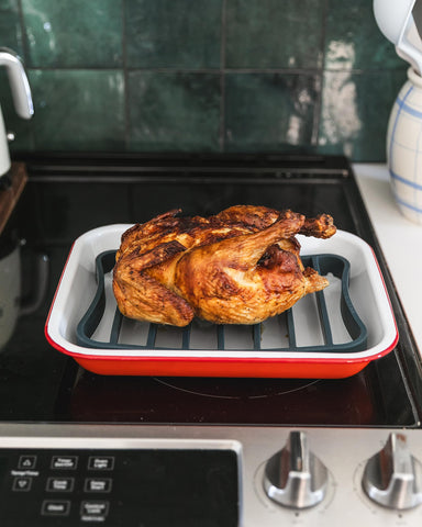 Two navy The Silicone Kitchen racks on a half-sheet provide broader coverage.