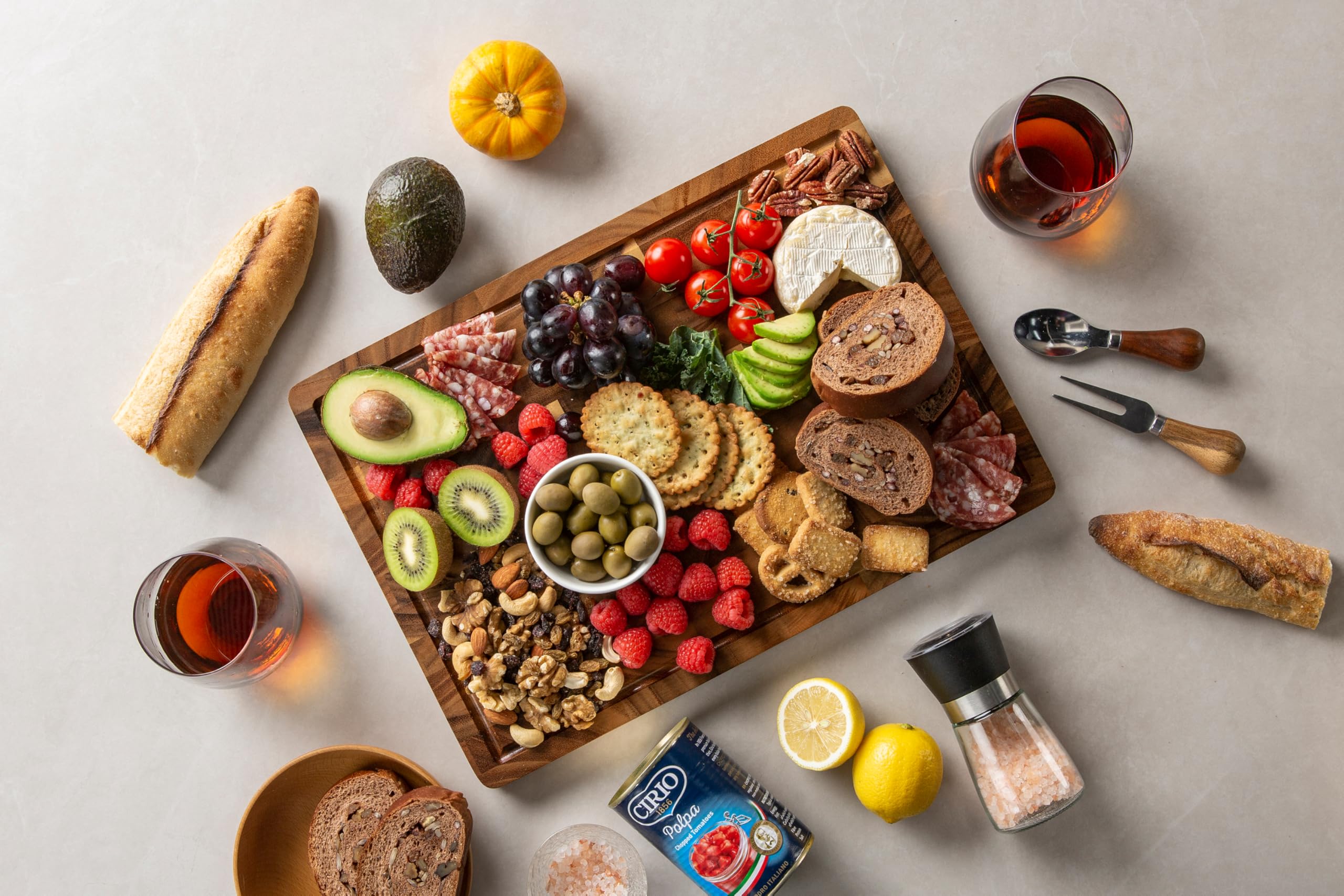 thetchry charcuterie-style serving board shows cheeses and fruits neatly arranged.