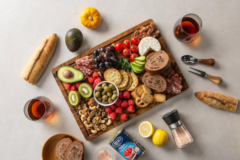 thetchry charcuterie-style serving board shows cheeses and fruits neatly arranged.