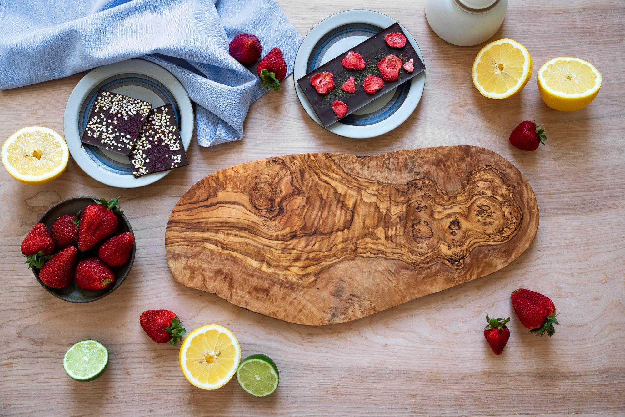 Thirteen Chefs cheese serving tray in olive wood adds warm tones for stylish platters.