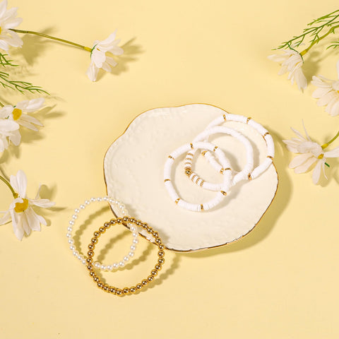 Silk hair scrunchie and flower clip included in the gift set for playful style