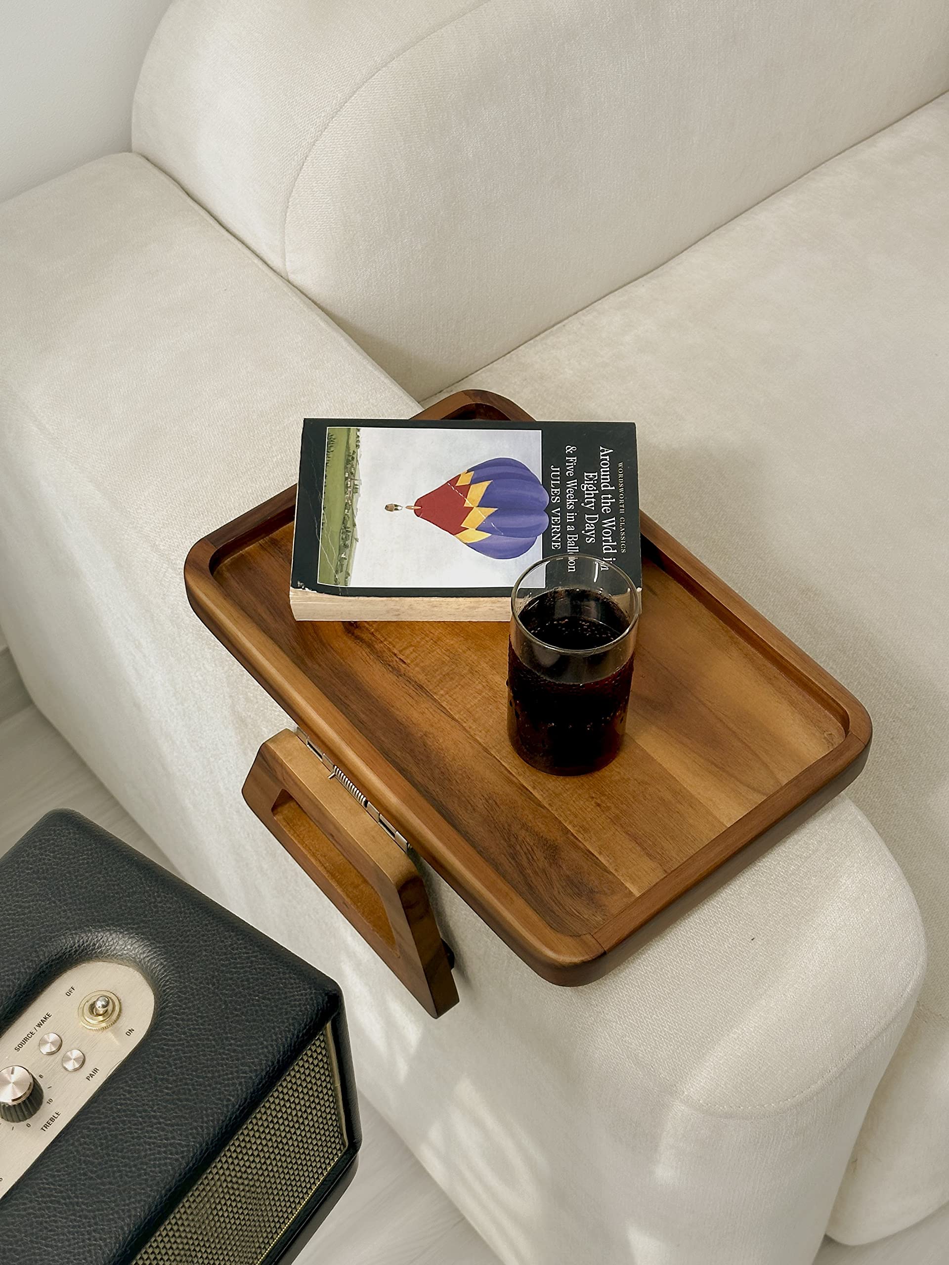 Tinamo portable armrest tray doubles as decorative display on sofa.