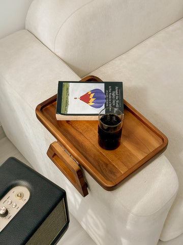 Tinamo portable armrest tray doubles as decorative display on sofa.
