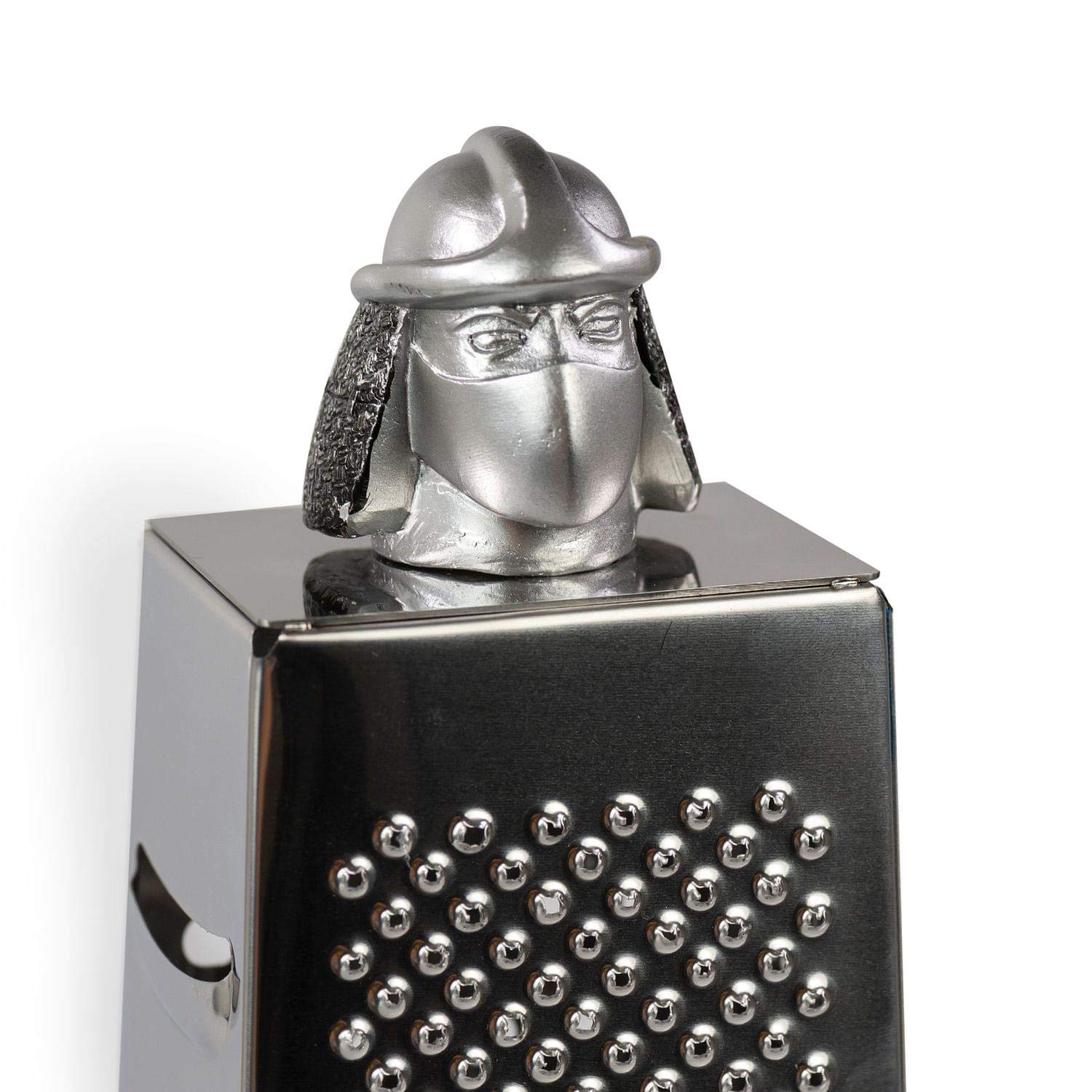 Teenage Mutant Ninja Turtles cheese grater in action on a fresh block.