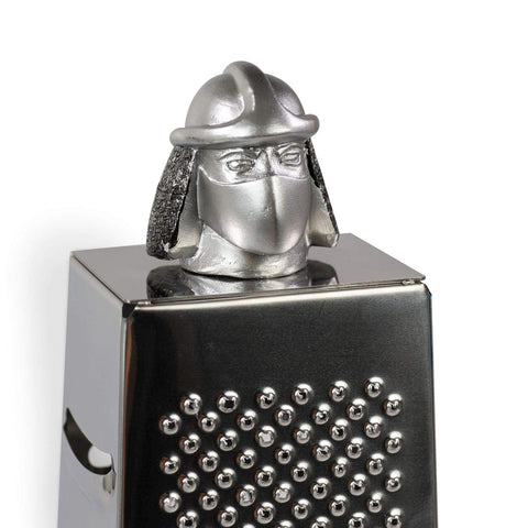 Teenage Mutant Ninja Turtles cheese grater in action on a fresh block.