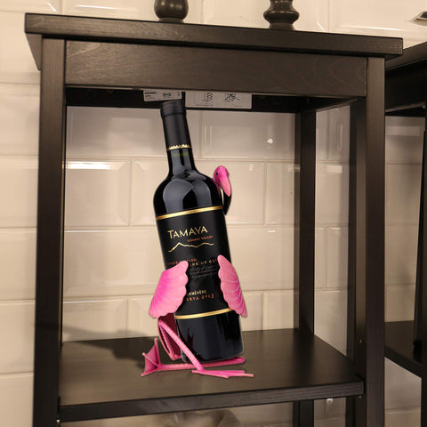 Tooarts decorative flamingo stands securely while holding a bottle.