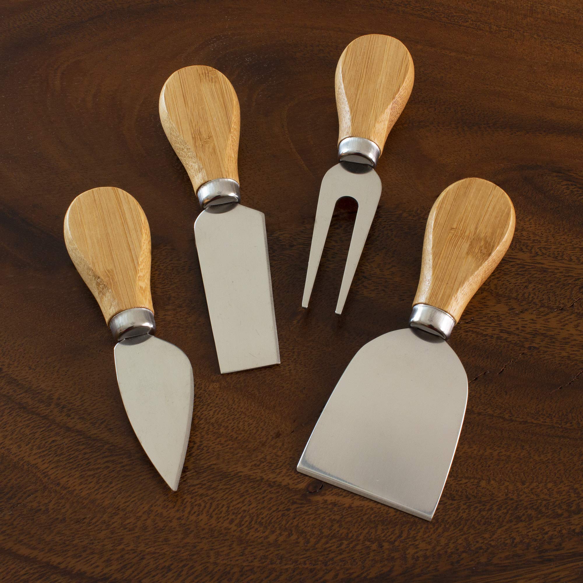 Totally Bamboo charcuterie board accessories set complements fruit, cheese, and meats.