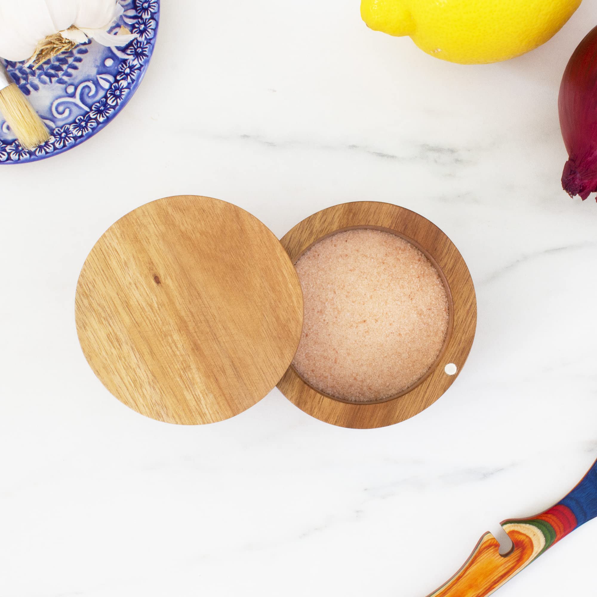 Totally Bamboo magnetic swivel lid demonstrates one handed access for quick seasoning.