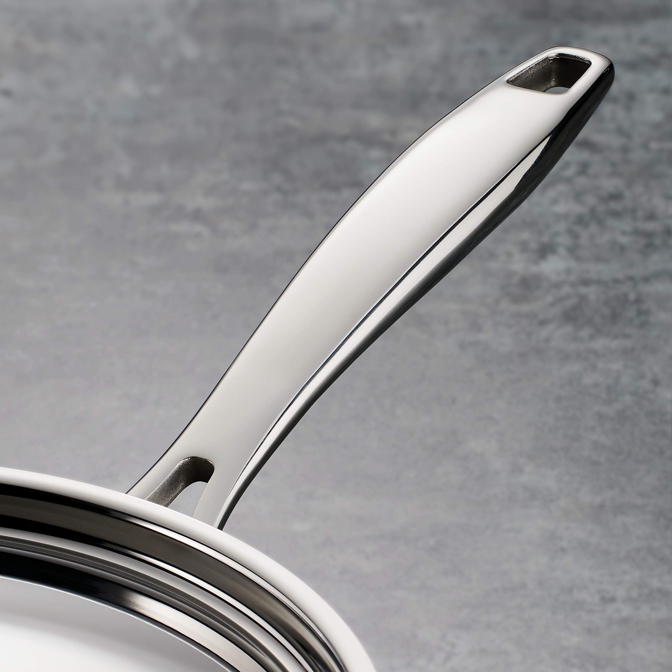 Tramontina tri-ply clad pan lid close-up emphasizes durable stainless steel construction.