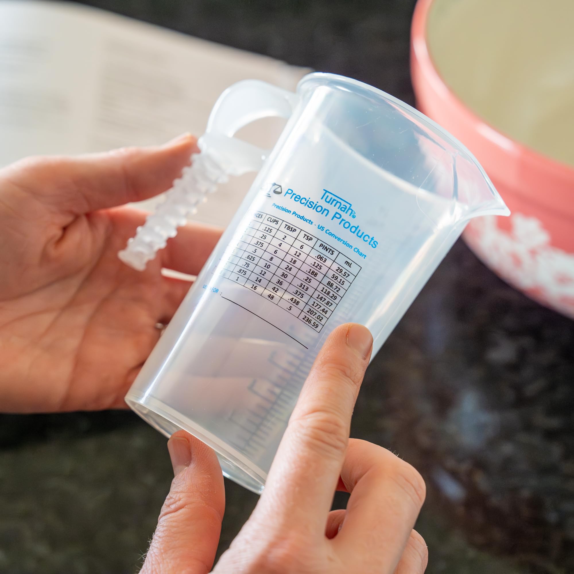 Turnah pitcher with clear measurements for precise pouring in cooking.