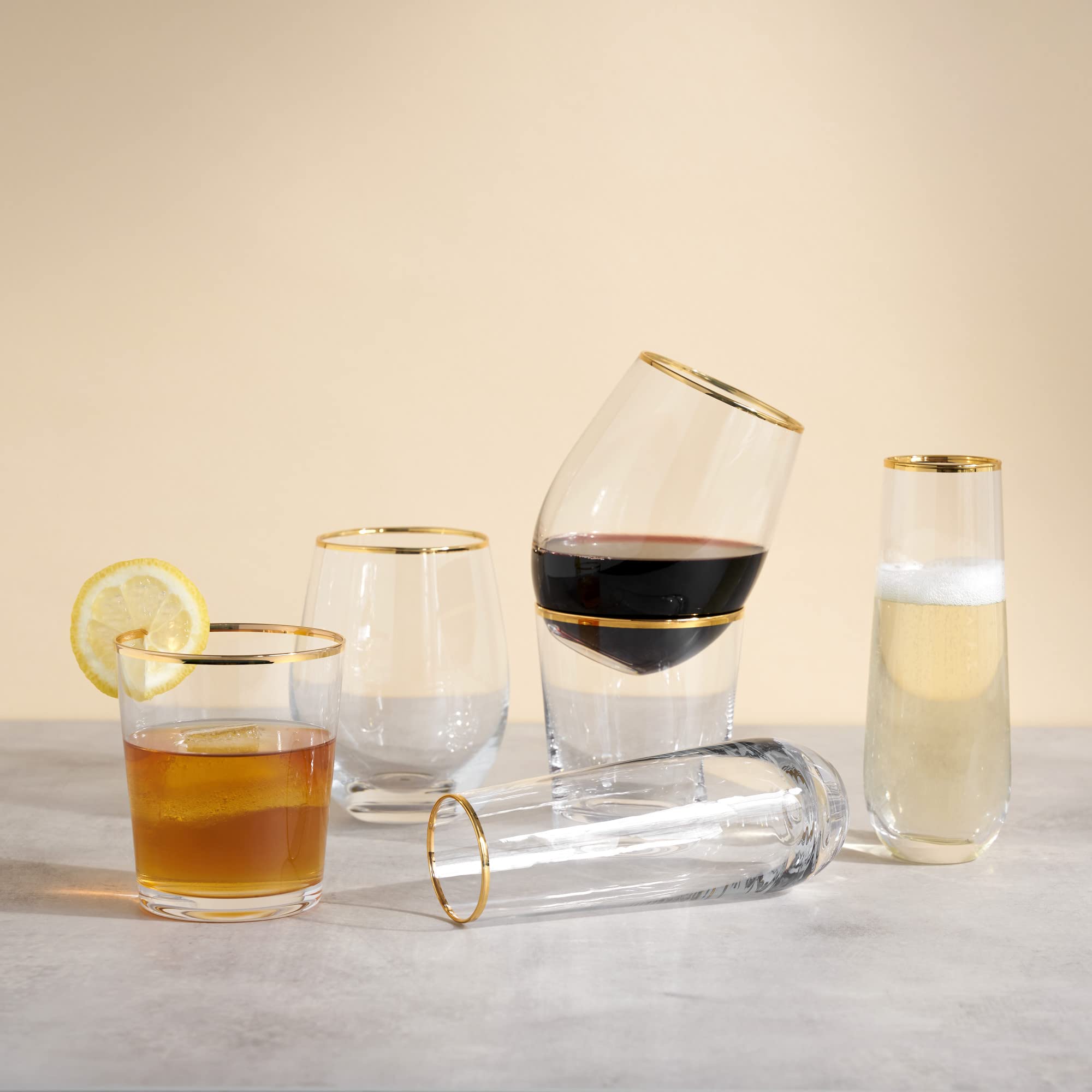 Twine bar cart with gilded-rim wine glasses elevating home bar display.
