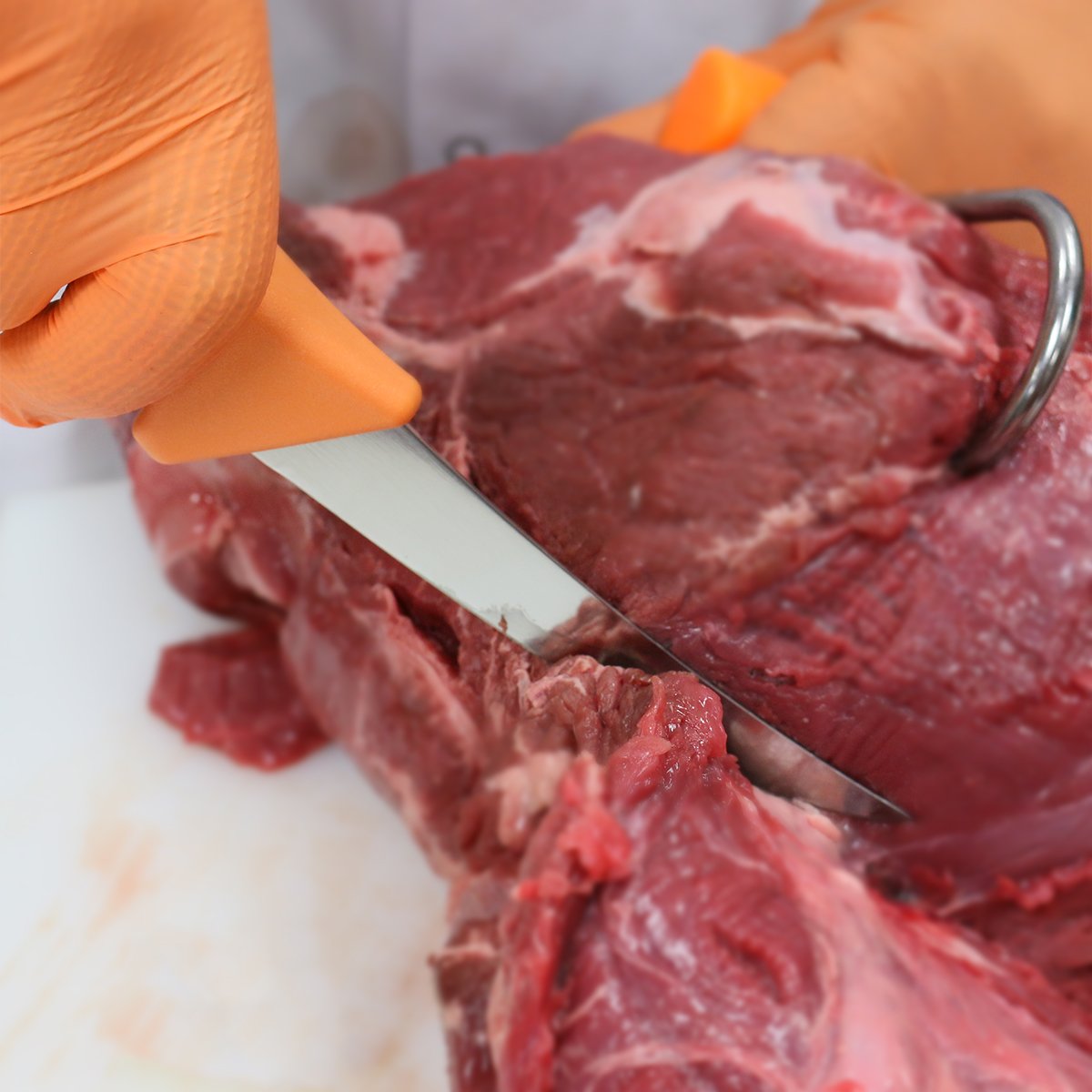 ULTRASOURCE knife demonstrates semi-flexible blade ideal for delicate meat trimming and maneuvering around bones.